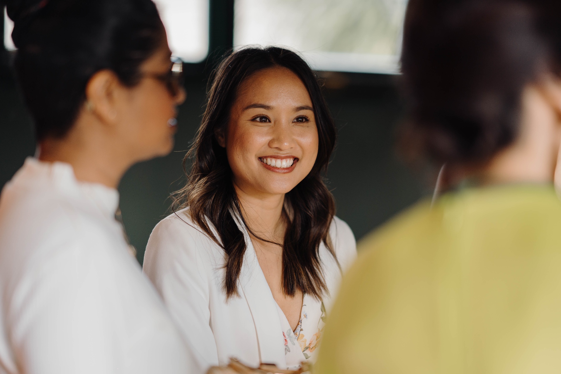 Member smiling in conversation