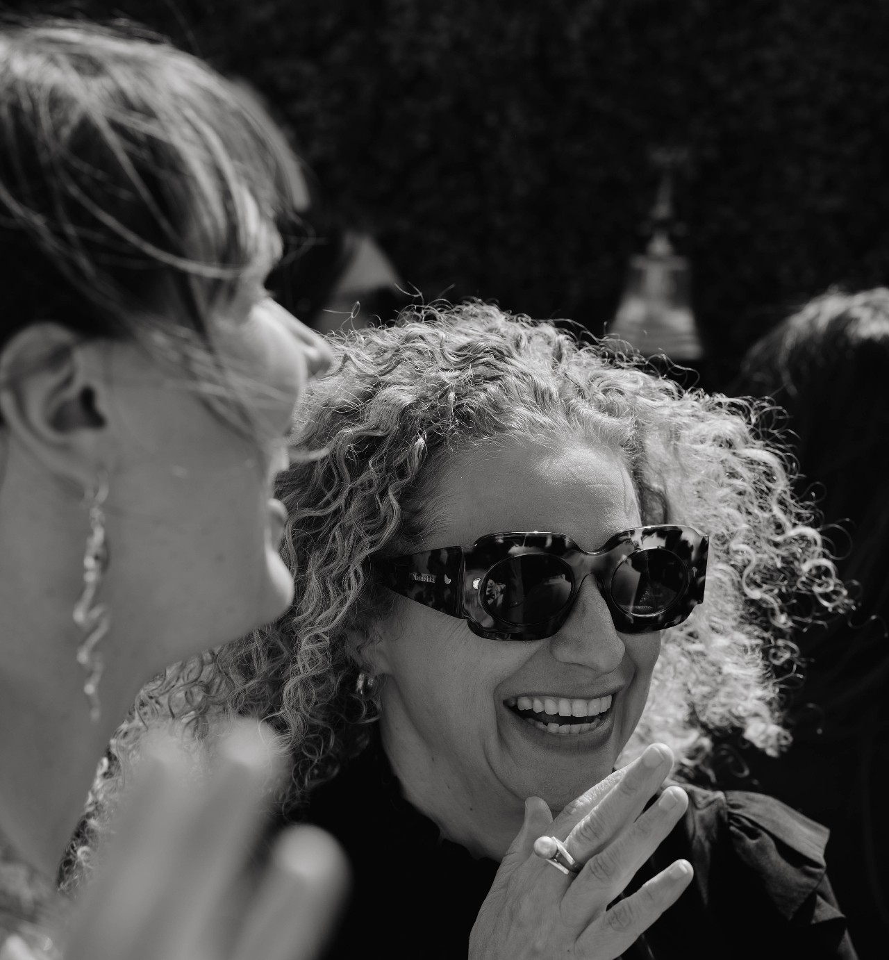 Member laughing in black and white